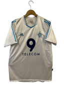 White hanging home soccer shirt with adidas logo, Olympique crest, blue number 9, TELECOM.