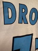 White jersey with large blue “DRO” lettering across the back.