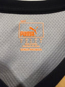 Football jersey Puma size label with Made in Brazil text, orange and grey