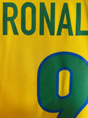 Brazil home soccer shirt front with RONAL 9 number and green crest-style badge