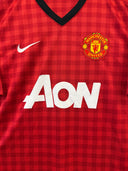 Red checkered football jersey front with Nike swoosh, Manchester United crest, AON