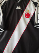 Black soccer jersey with diagonal white panel, red trim, and white-red crest