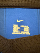 Blue football shirt interior with yellow brand label near collar