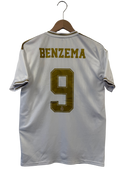 White football jersey on a hanger with BENZEMA name and gold #9 on the back