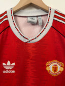 Red Manchester United home football shirt with adidas logo and Manchester United crest