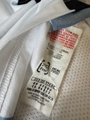 Long-sleeve home football shirt, white with dark trim; interior size/brand tag visible