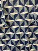 Navy football shirt with repeating geometric triangle pattern in cream and teal