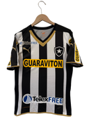 Black-and-white striped football jersey on hanger with yellow GUARAVITON sponsor