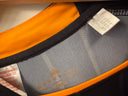 Black sports jersey collar with orange trim and inner size tag