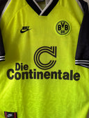 Lime yellow Borussia Dortmund soccer jersey with 'Die Continentale' sponsor and Nike logo