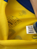 Yellow Al Nassr home soccer shirt with Adidas logos and Al Nassr crest patch