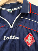 Navy soccer jersey collar with red piping, Lotto logo, and red crest patch