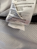Football jersey care label stitched inside collar, white with black text