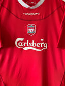 Red Liverpool home soccer shirt with Reebok logo, crest, and Carlsberg sponsor