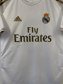 White Real Madrid home football jersey with Adidas logo, crest, and Fly Emirates
