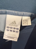 Adidas soccer jersey size and fabric label on dark blue collar