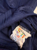 Navy soccer shirt fabric with interior size and wash label near hem seam