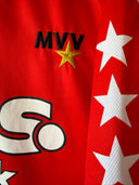 Red football shirt sleeve with MVV logo, gold star, and white star graphics
