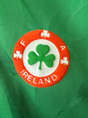 Green soccer home shirt with round Ireland crest patch in orange and white