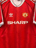 Red Manchester United home football shirt with white adidas logo, SHARP sponsor, crest