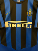 Blue and black striped Inter home football jersey with Pirelli sponsor and star