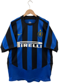 Blue and black striped Inter home football jersey with Nike swoosh and Pirelli