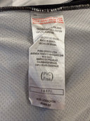 Football jersey fabric tag with PUMA details and size info on grey interior