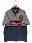 Football shirt on hanger with crest, sponsor, and blue pinstripe lower panel