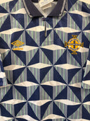 Away football shirt with navy geometric print and crest logos on chest