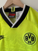 Lime yellow Borussia Dortmund home soccer jersey with black V-neck and BVB 09 crest