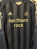 Dark blue striped soccer jersey with northern rock logo and Newcastle crest
