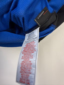 Blue football shirt with black Nike tag and white care labels