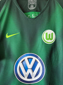 Green football jersey close-up with Nike swoosh, Wolfsburg crest, and VW emblem
