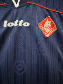 Navy soccer jersey front with Lotto logo, red trim, and red crest patch