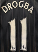 Black football jersey back with DROGBA name and two white 11 number prints