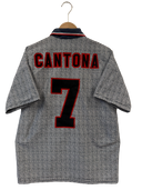 Football shirt back with 'CANTONA' and red number '7'
