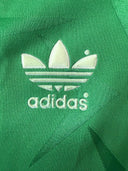 Green soccer home shirt showing white adidas trefoil logo on chest